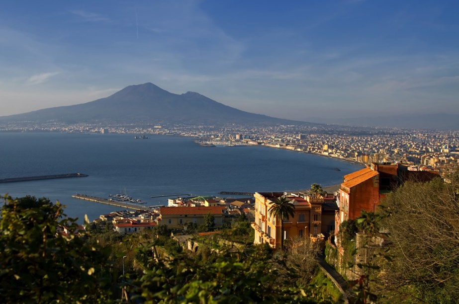 Vista clássica do porto de Napóles, com o Vesúvio ao fundo; para ter esse visual na sua câmera fotográfica, passeie entre os prédios do Teatro San Carlo, do Castel Nuovo e pelos arredores da Piazza del Pebliscito