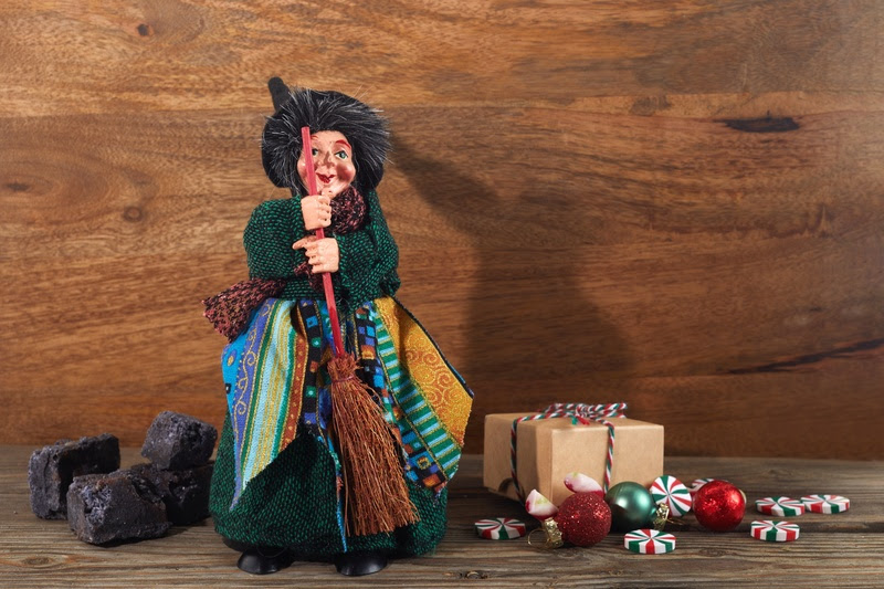 The Befana with sweet coal and candy. Italian Epiphany day tradition.